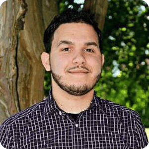 School Pathways Software Developer Matthew Richardson smiles to camera, weating a black and white checkered shirt